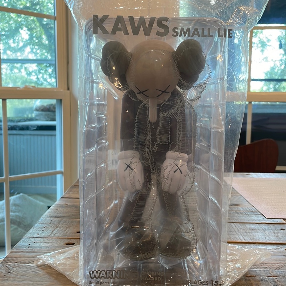 Unopened KAWS Small lie in brown, pristine condition